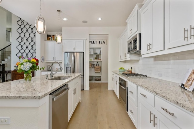 202 Hazy Hills Loop, Dripping Springs, TX 78620 - kitchen featuring appliances with stainless steel finishes, white cabinetry, a kitchen island with sink, tasteful backsplash, and recessed lighting