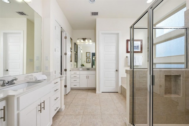 202 Hazy Hills Loop, Dripping Springs, TX 78620 - bathroom featuring a shower stall, two vanities, and tile patterned flooring