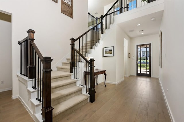 202 Hazy Hills Loop, Dripping Springs, TX 78620 - entrance foyer with wood-type flooring, stairway, and a towering ceiling
