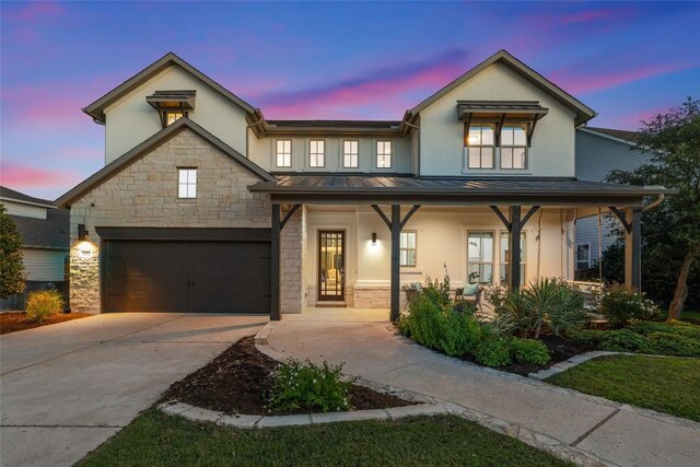 202 Hazy Hills Loop, Dripping Springs, TX 78620 - view of front facade with a standing seam roof, stucco siding, a porch, and driveway
