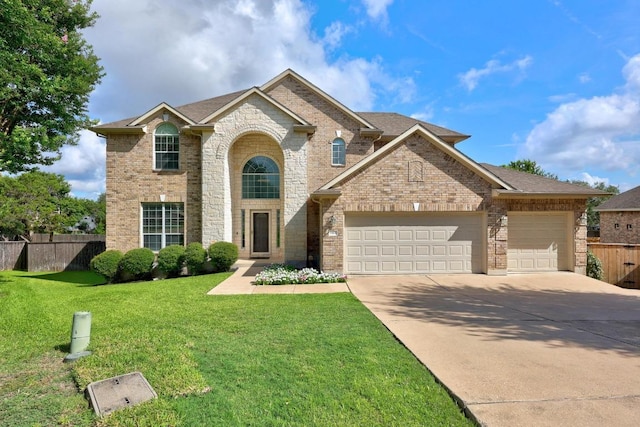 1901 Phantom Horse, Leander, TX 78641 - traditional-style home with an attached garage, concrete driveway, brick siding, and roof with shingles