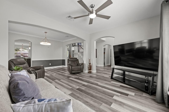 1901 Phantom Horse, Leander, TX 78641 - living area featuring a ceiling fan, arched walkways, wood finished floors, and ornamental molding