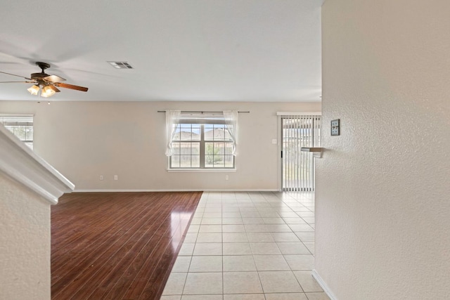 201 Windridge Dr N, Lockhart, TX 78644 - spare room featuring a ceiling fan, healthy amount of natural light, light wood finished floors, and a textured wall