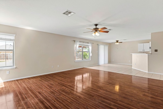 201 Windridge Dr N, Lockhart, TX 78644 - unfurnished living room featuring ceiling fan and light wood-style floors