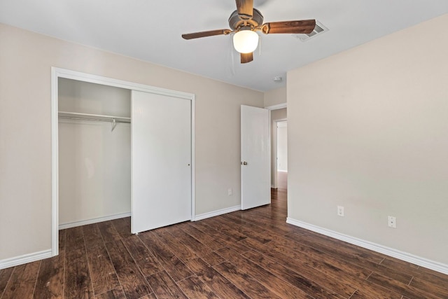 201 Windridge Dr N, Lockhart, TX 78644 - unfurnished bedroom with dark wood finished floors, a closet, and ceiling fan