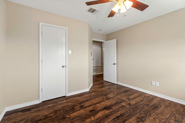 201 Windridge Dr N, Lockhart, TX 78644 - unfurnished bedroom with dark wood-style flooring and ceiling fan