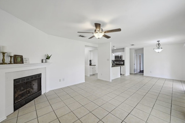 2309 New Hope Spur, Cedar Park, TX 78613 - unfurnished living room featuring a fireplace, a ceiling fan, and light tile patterned flooring