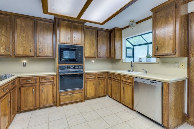 506 Applewood Dr, Pflugerville, TX 78660 - kitchen with black appliances, light countertops, light tile patterned floors, and brown cabinetry