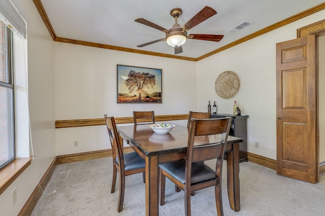 506 Applewood Dr, Pflugerville, TX 78660 - dining room with light carpet, ceiling fan, and ornamental molding