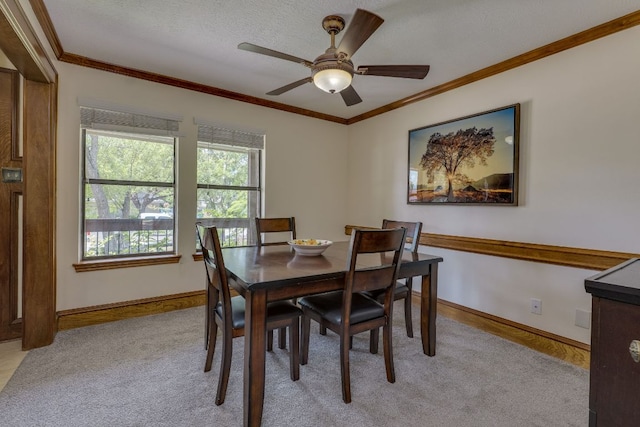 506 Applewood Dr, Pflugerville, TX 78660 - dining space featuring light carpet, a ceiling fan, and crown molding