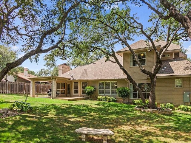103 El Norte Ct, Lakeway, TX 78734 - back of property featuring a chimney, a patio area, and a shingled roof