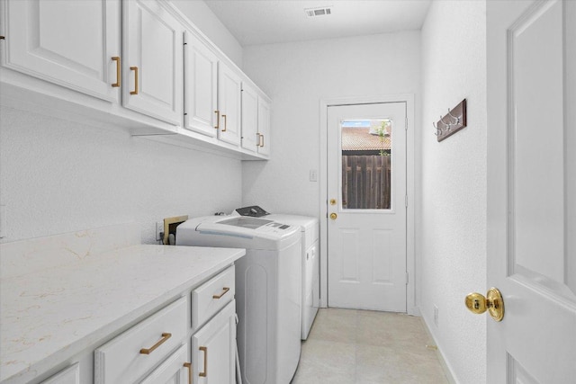 103 El Norte Ct, Lakeway, TX 78734 - laundry room with washing machine and dryer and cabinet space