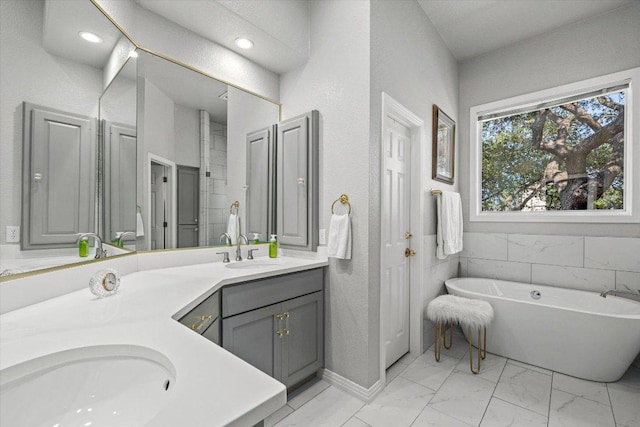 103 El Norte Ct, Lakeway, TX 78734 - full bathroom with double vanity, a soaking tub, and marble look tile flooring