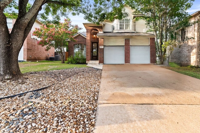 10919 Sierra Oaks, Austin, TX 78759 - view of front of home featuring brick siding, a garage, and driveway