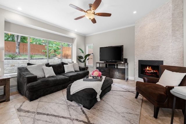 10919 Sierra Oaks, Austin, TX 78759 - tiled living room with crown molding, a stone fireplace, ceiling fan, and recessed lighting