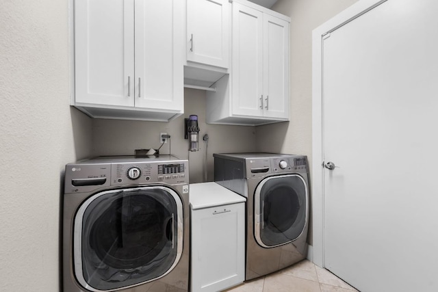 10919 Sierra Oaks, Austin, TX 78759 - laundry area with cabinet space, washer and dryer, and light tile patterned floors