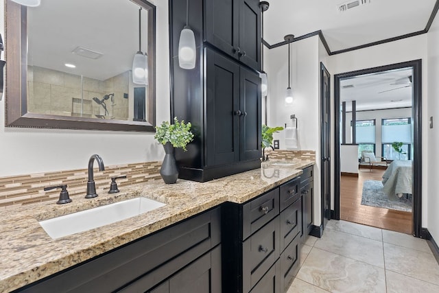 2717 Jorwoods Dr, Austin, TX 78745 - bathroom with double vanity, tiled shower, ensuite bath, tasteful backsplash, and tile patterned flooring