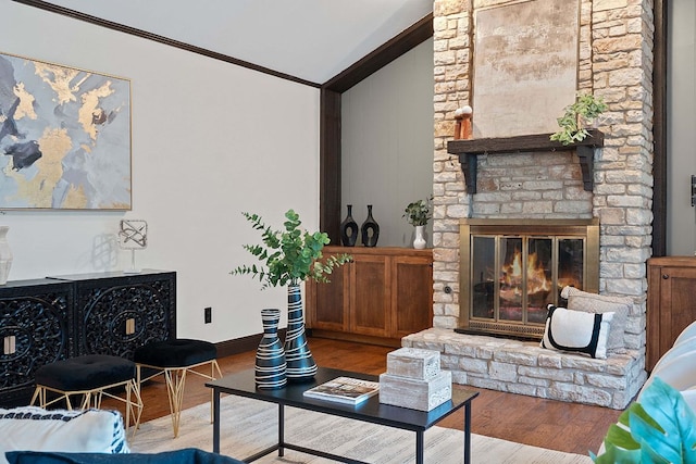 2717 Jorwoods Dr, Austin, TX 78745 - living area with lofted ceiling, crown molding, wood finished floors, and a stone fireplace