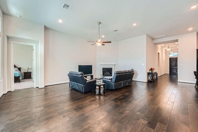 6716 Calabria Dr, Round Rock, TX 78665 - living room featuring dark wood-style flooring, ceiling fan, a glass covered fireplace, and recessed lighting