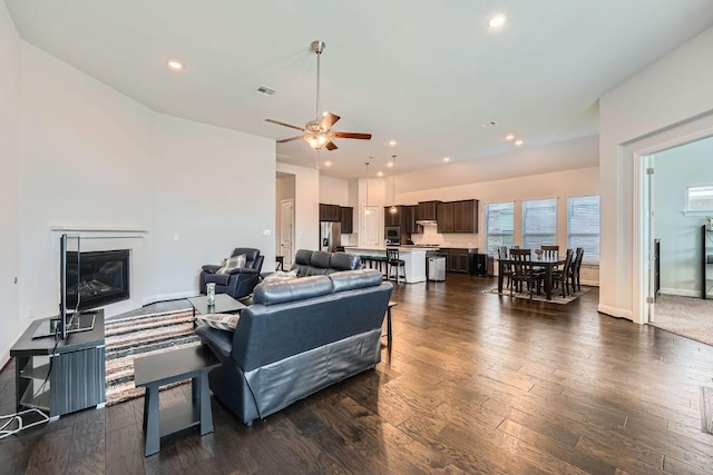 6716 Calabria Dr, Round Rock, TX 78665 - living room with ceiling fan, a glass covered fireplace, dark wood-style floors, and recessed lighting