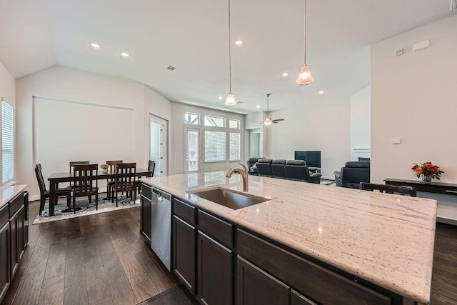 6716 Calabria Dr, Round Rock, TX 78665 - kitchen with stainless steel dishwasher, dark wood-type flooring, a center island with sink, light stone countertops, and recessed lighting