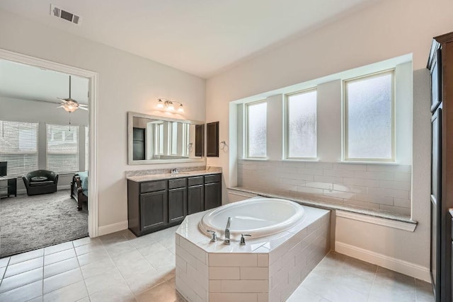 6716 Calabria Dr, Round Rock, TX 78665 - bathroom featuring a garden tub, vanity, tile patterned floors, and a ceiling fan