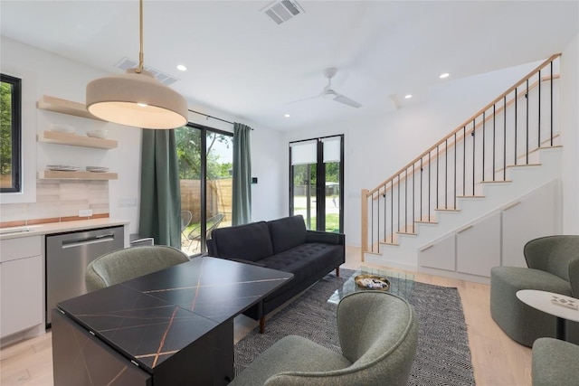 87 Chalmers Ave, Austin, TX 78702 - living room with recessed lighting, stairway, and light wood-style flooring