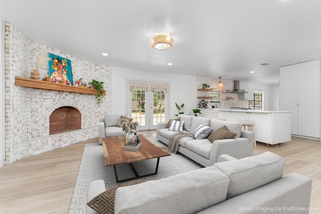 1001 E Applegate Dr, Austin, TX 78753 - living area featuring light wood finished floors, plenty of natural light, recessed lighting, a fireplace, and french doors