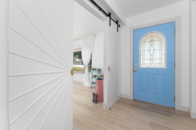 1001 E Applegate Dr, Austin, TX 78753 - foyer featuring a barn door and light wood-style floors