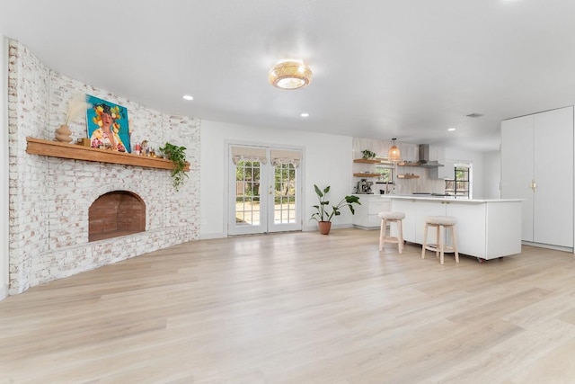 1001 E Applegate Dr, Austin, TX 78753 - living room featuring light wood finished floors, healthy amount of natural light, recessed lighting, and a brick fireplace