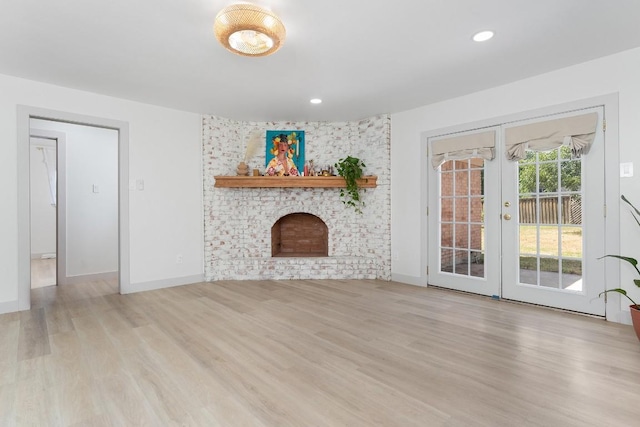 1001 E Applegate Dr, Austin, TX 78753 - unfurnished living room featuring wood finished floors, a fireplace, french doors, and recessed lighting