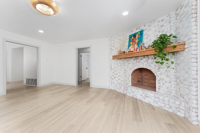1001 E Applegate Dr, Austin, TX 78753 - unfurnished living room featuring wood finished floors, recessed lighting, and a brick fireplace