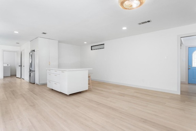 1001 E Applegate Dr, Austin, TX 78753 - empty room with washer / dryer, light wood-style floors, and recessed lighting