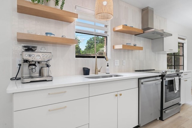 1001 E Applegate Dr, Austin, TX 78753 - kitchen with open shelves, wall chimney exhaust hood, stainless steel appliances, white cabinetry, and light countertops