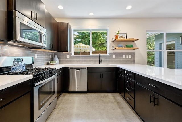 301 W Stassney Ln Unit 11, Austin, TX 78745 - kitchen featuring stainless steel appliances, concrete floors, light countertops, decorative backsplash, and recessed lighting