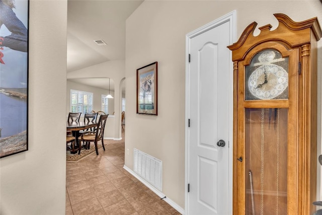 2201 Christoff Loop, Austin, TX 78748 - hallway with light tile patterned floors and vaulted ceiling