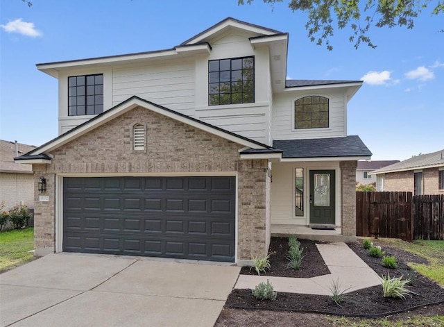 15532 Emmaleighs Ln, Pflugerville, TX 78660 - view of front facade with driveway, brick siding, covered porch, and a shingled roof