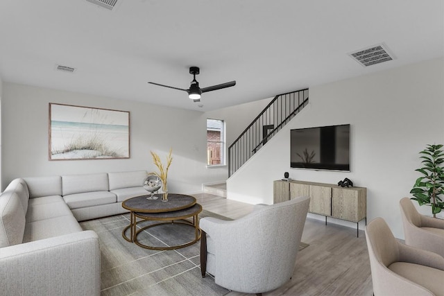 15532 Emmaleighs Ln, Pflugerville, TX 78660 - living area featuring wood finished floors, a ceiling fan, and stairs