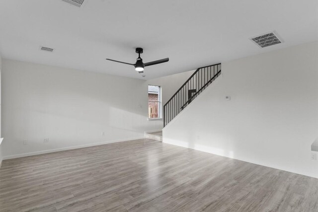 15532 Emmaleighs Ln, Pflugerville, TX 78660 - unfurnished living room with wood finished floors, ceiling fan, and stairs