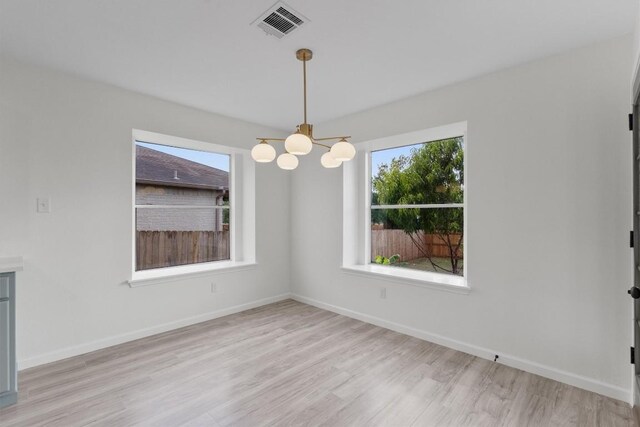 15532 Emmaleighs Ln, Pflugerville, TX 78660 - unfurnished room featuring a chandelier and light wood-style floors