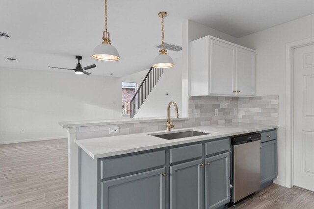 15532 Emmaleighs Ln, Pflugerville, TX 78660 - kitchen featuring dishwasher, backsplash, light countertops, and light wood finished floors