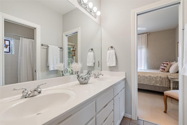 2115 W 11th St, Austin, TX 78703 - ensuite bathroom featuring double vanity, tile patterned floors, and healthy amount of natural light