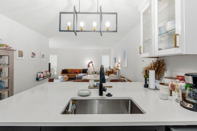 3431 N Hills Dr Unit 112, Austin, TX 78731 - kitchen featuring open floor plan, light countertops, white cabinetry, and glass insert cabinets