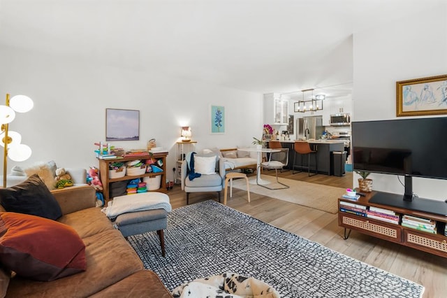 3431 N Hills Dr Unit 112, Austin, TX 78731 - living room with light wood finished floors and a chandelier