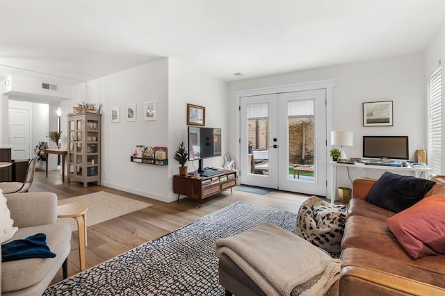 3431 N Hills Dr Unit 112, Austin, TX 78731 - living room featuring french doors and light wood-style flooring