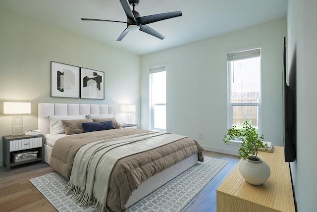 3431 N Hills Dr Unit 112, Austin, TX 78731 - bedroom featuring multiple windows, wood finished floors, and a ceiling fan