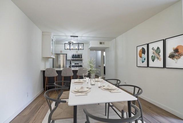 3431 N Hills Dr Unit 112, Austin, TX 78731 - dining area with light wood-type flooring