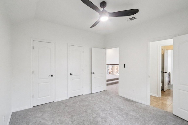 12404 Calistoga Way, Austin, TX 78732 - unfurnished bedroom with carpet flooring, vaulted ceiling, a ceiling fan, and two closets