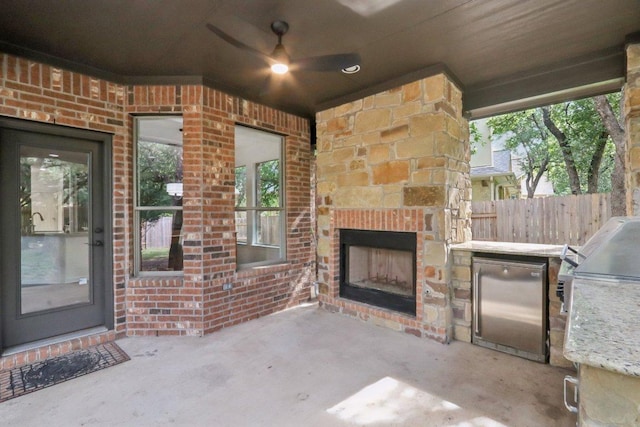 12404 Calistoga Way, Austin, TX 78732 - view of patio featuring an outdoor stone fireplace and exterior kitchen