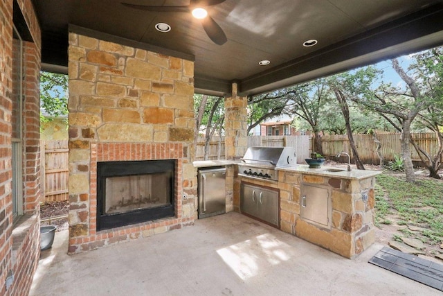 12404 Calistoga Way, Austin, TX 78732 - fenced backyard with an outdoor stone fireplace, area for grilling, and a patio area